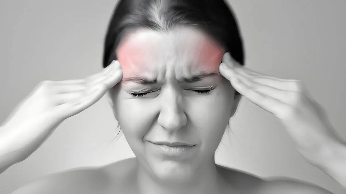 Photo of woman pinpointing area of pain in head