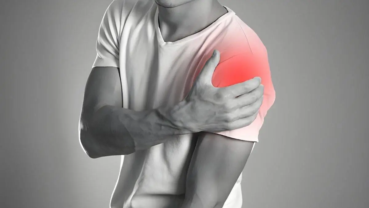 Photo of man holding shoulder pinpointing area of pain
